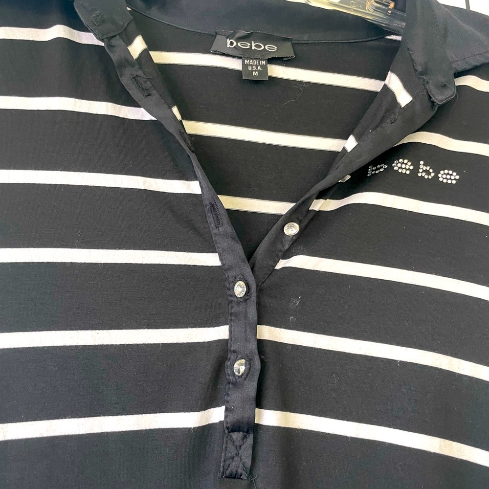 Black and white stripe BEBE button shirt. Sparkly logo on the side.